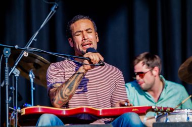 Ben Harper performing on stage during  music concert   clipart