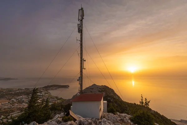 Mobile phone base station located on the mountain above the Aegean Sea