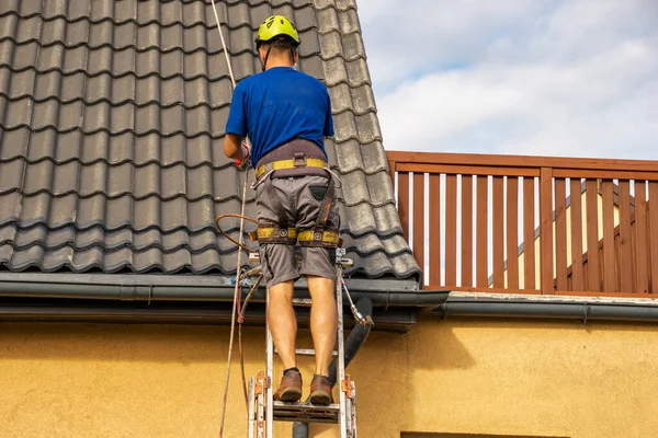  Bir çatı boyayan yüksek irtifa işçisi