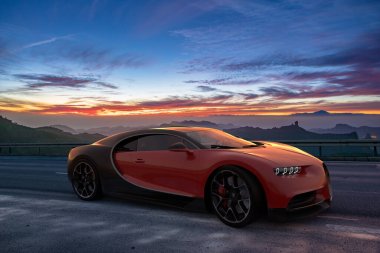 Bugatti Chiron on a beautiful scenic road in the mountains at sunset clipart