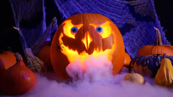 Halloween pumpkin Jack o lantern with heavy smoke. Halloween pumpkins on spooky background, misty fog. October holidays concept. Perfect carved pumpkin and autumn spooky decoration.