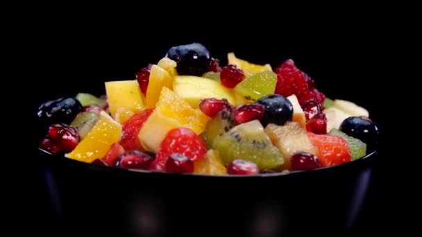 Colorful Fruit Salad Bowl Rotating Black Background Close Fresh Tasty — Stock Video
