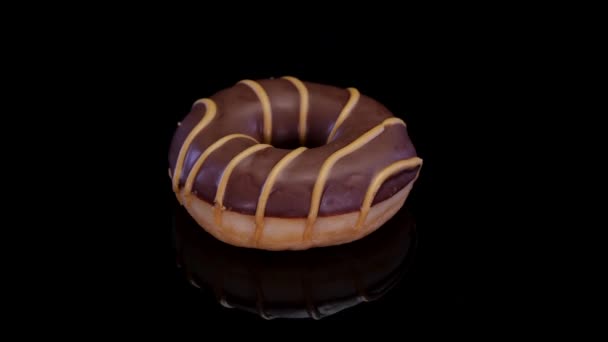 Donut Con Glaseado Caramelo Chocolate Girando Sobre Fondo Negro Rosquilla — Vídeos de Stock