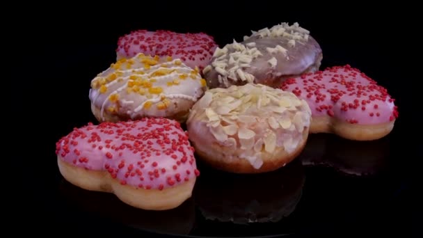 Different Donuts Buns Icing Frosting Powdered Sugar Rotating Black Background — Stock Video