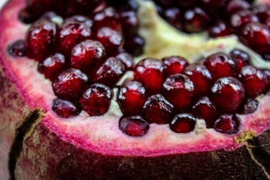 Nar tohumunu kapat. Olgun kırmızı nar tohumlarının görüldüğü açık nar meyvesi. Meyve aromalı. Makro.