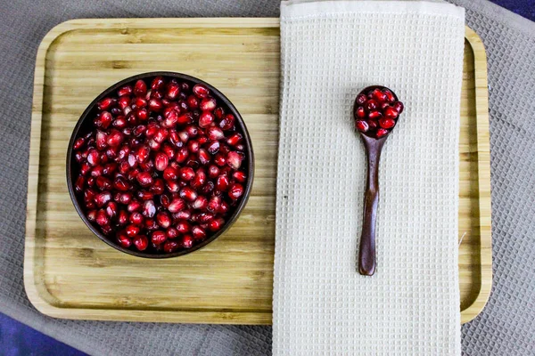 Red Pomegranate Seeds Wooden Bowl Wooden Spoon Seeds Next Napkin — Stock Photo, Image