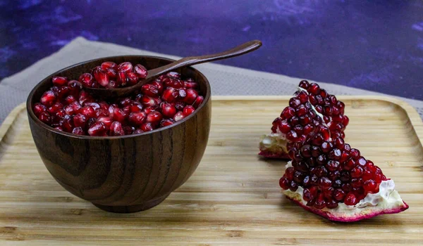 Red Pomegranate Seeds Close Wooden Bowl Wooden Spoon Two Pieces — Stock Photo, Image