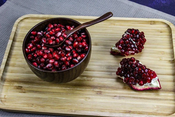 Red Pomegranate Seeds Close Wooden Bowl Wooden Spoon Two Pieces — Stock Photo, Image