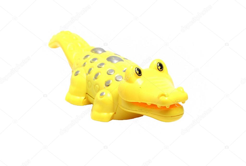yellow crocodile toy on a white background