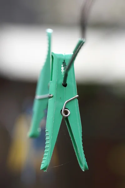 Green clothespin for clothing on the background bokeh — Stock Photo, Image