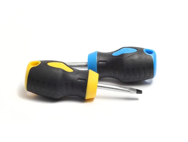 Two yellow black and yellow black and blue screwdrivers on a whi — Stock Photo, Image