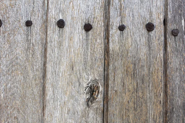 Texture of a piece of a wooden door with nails — Stock Photo, Image