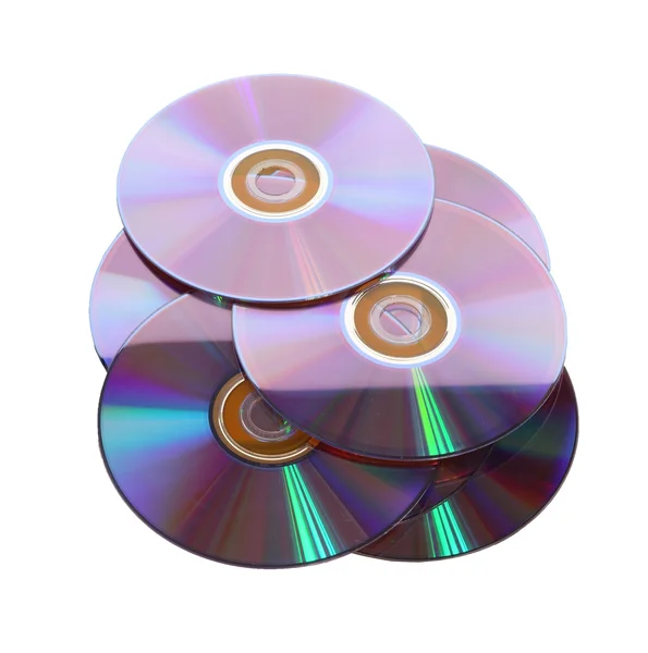 Несколько компакт-дисков, лежащих в основе белого стола — стоковое фото