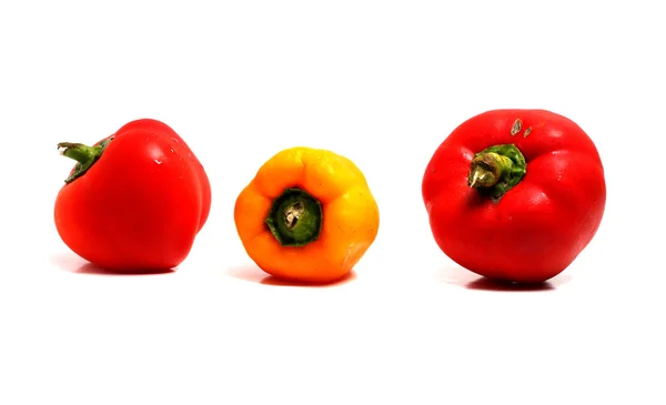 Três pimentas maduras sobre um fundo branco — Fotografia de Stock