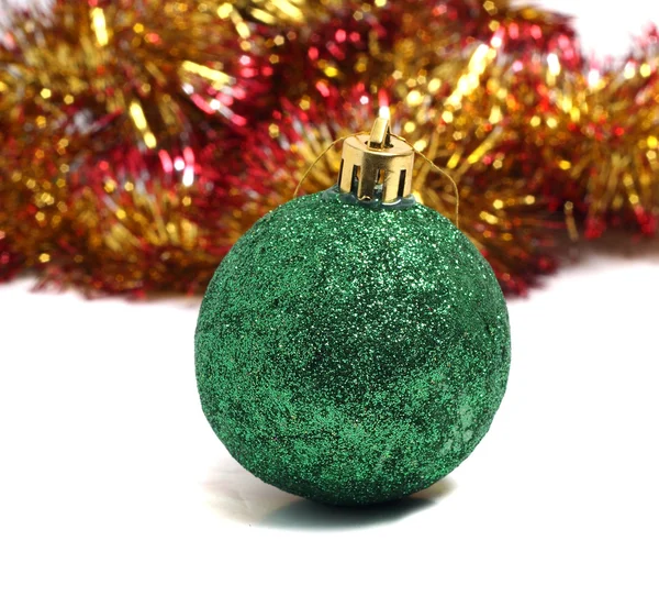 Christmas ball on green background of holiday decorations