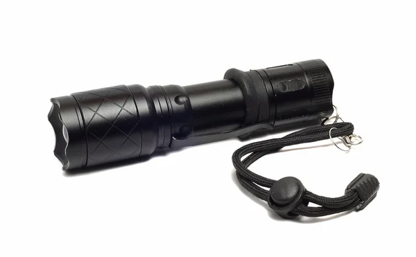 Small black flashlight on a white background — Stock Photo, Image