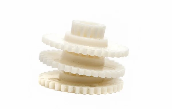 Tres engranajes plásticos polvorientos aislados sobre un fondo blanco — Foto de Stock