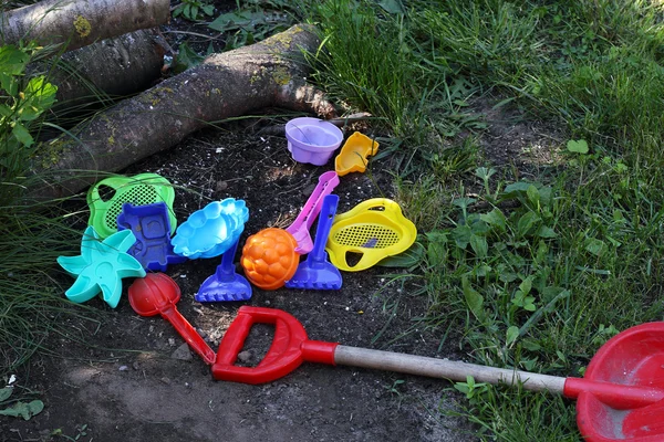 Colored toys on the grass and earth — Stock Photo, Image