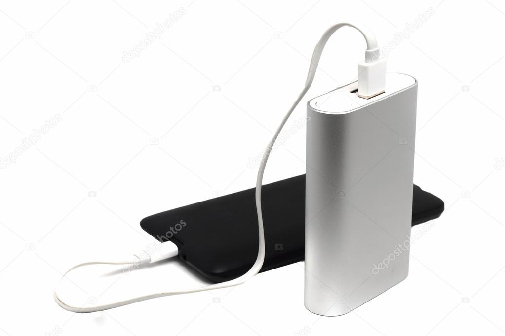 dusty mobile phone and an external battery on a white background