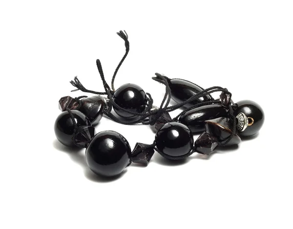 Bracelet on the arm of the black balls on the white — Stock Photo, Image