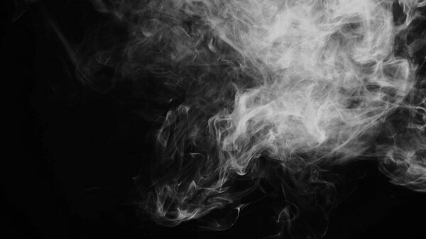 Unhealthy lifestyle . cigarette smoke clouds draws artistic abstract patterns. dark background