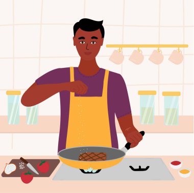 Hintli zenci adam mutfağında yemek pişiriyor. Kırmızı gömlekli ve yeşil önlüklü bir erkek kızartma tavasında biftek pişiriyor. Eldeki tuz. Çizgi film vektör illüstrasyonu