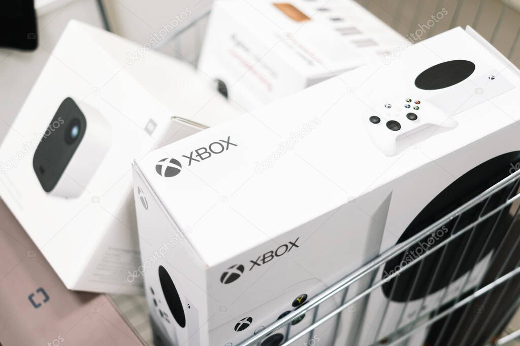 XBOX and boxes with gadgets in the shopping trolley. High quality photo