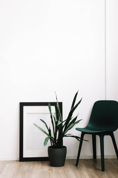 Minimal interior design of living room with green chair and houseplan. High quality photo