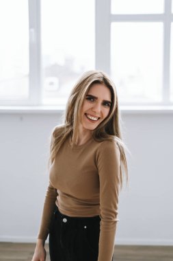 Parlak oturma odasında büyük pencereli beyaz bir kadının portresi. Yüksek kalite fotoğraf