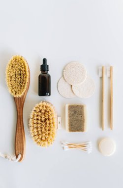 Kişisel bakım için doğal çevre dostu aksesuarlar, kuru masaj fırçaları, bambu diş fırçaları, lifli yüz süngerleri ve beyaz arka planda izole edilmiş doğal sabunlar..