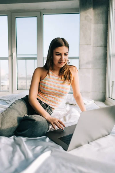 Young Caucasian Woman Resting Bed Home Using Laptop Computer Chatting — Stock Fotó