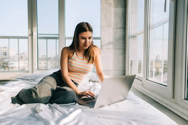 Young Caucasian Woman Resting Bed Home Using Laptop Computer Chatting — Stock Fotó