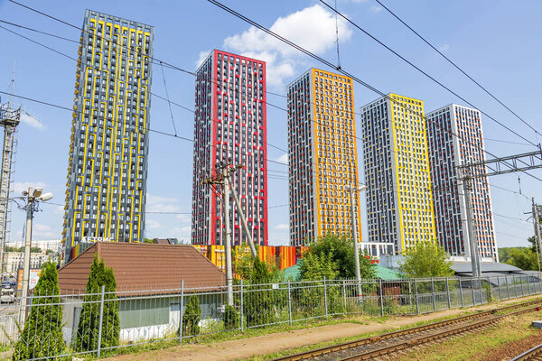 Moscow region, Russia - July 11, 2021: Modern multicolored residential buildings near the railway station Pavshino