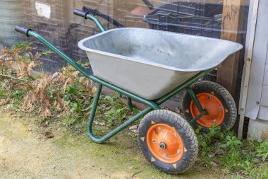 Bahçede ve arka bahçede inşaat malzemeleri taşımak için demir el arabası.