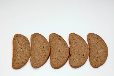 Beyaz arka planda birkaç parça çavdar ekmeği.