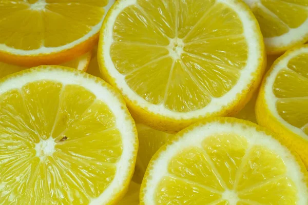 lemons cut into circles, slices on a white background photographed by macro shooting