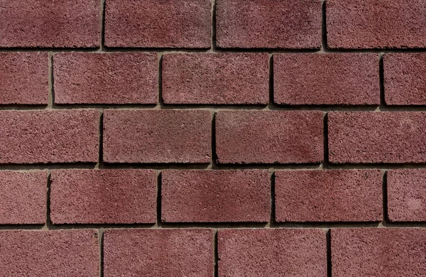 stock image dark red brick background sunny day with light and shadows