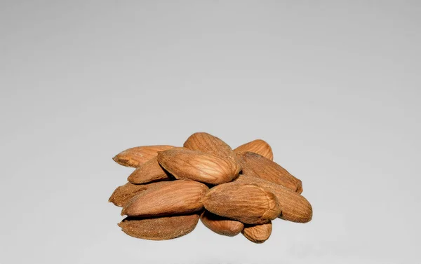 Handful Peeled Almonds Light Gray Background Photographed Close — Stock Photo, Image