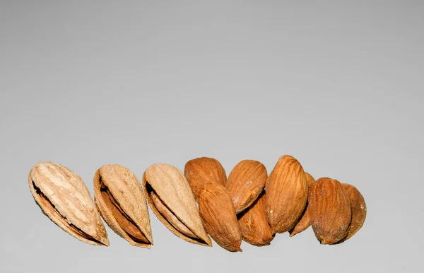 Handful Peeled Almonds Unpeeled Light Gray Background Photographed Close — Stock Photo, Image