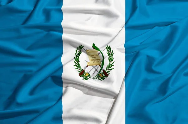 Bandera de Guatemala sobre una cortina de seda ondeando — Foto de Stock