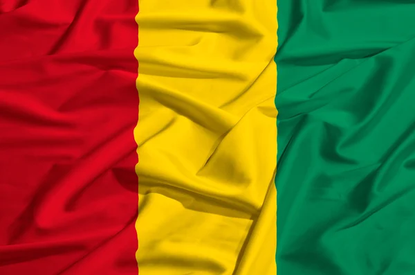 Guinea flag on a silk drape waving — Stock Photo, Image