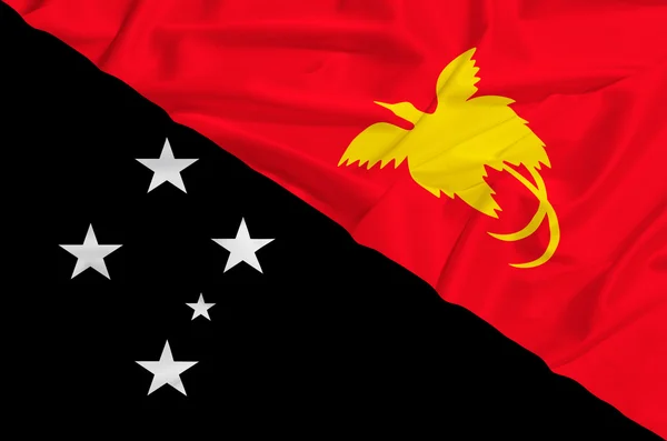 Papua nova bandeira da Guiné em uma cortina de seda acenando — Fotografia de Stock