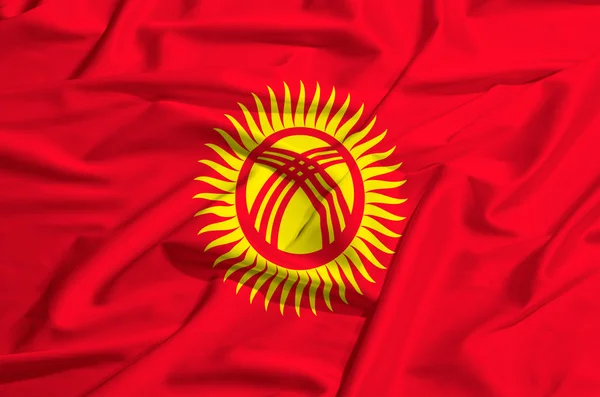 Kirgizië vlag op een zijden gordijn zwaaien — Stockfoto