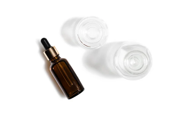 Glass cosmetic bottles on a white background. — Stock Photo, Image