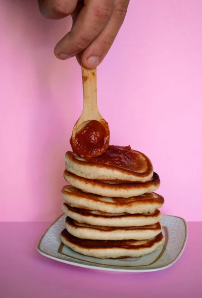 Man Spreads Jam Pancakes — Stock Photo, Image