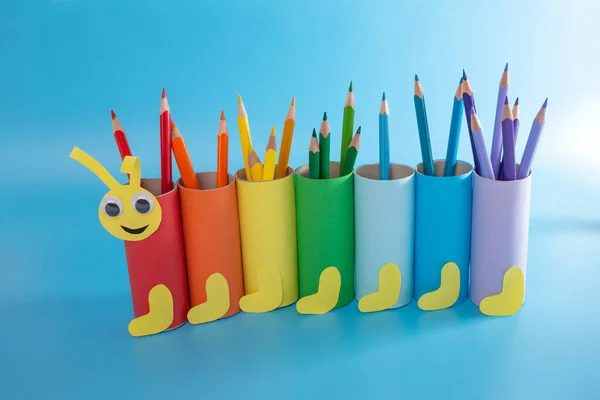 Caterpillar pencil holder, toilet paper roll craft concept, colorful tubes on blue background — Stock Photo, Image