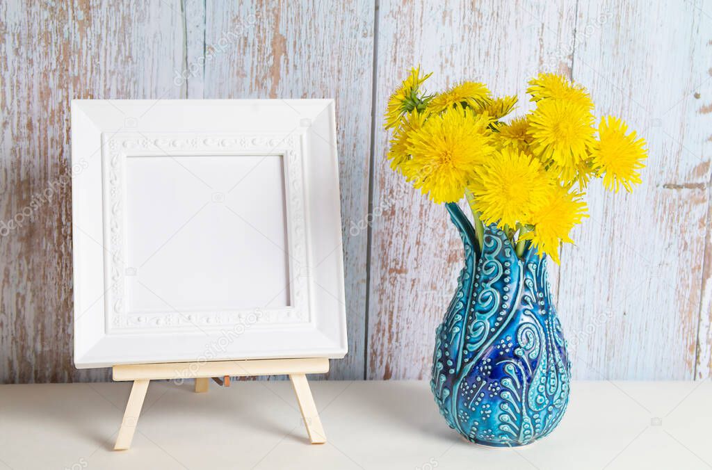 Dandelion bouquet in a vase and picture frame with copy space for mockup. High quality photo