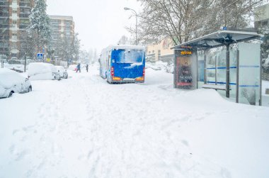 MADRID, SPAIN - JANUARY 9, 2021: Bus stop seen during Storm Filomena, the heaviest snowfall in 50 years in Madrid, Spain clipart
