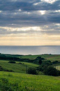 Gün batımında Cantabria 'nın yeşil sahili.