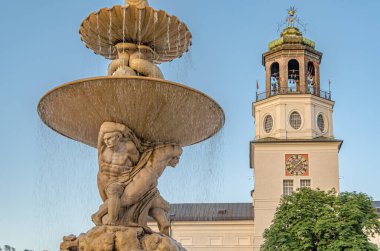 SALZBURG, AUSTRIA - 5 Temmuz 2015: Residenzbrunnen Barok çeşmesi Residenzplatz 'da Salzburg Müzesi binası arka planda tarihi eski Salzburg, Avusturya